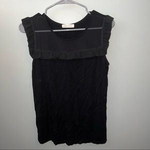 Women’s black top with sheer neckline.